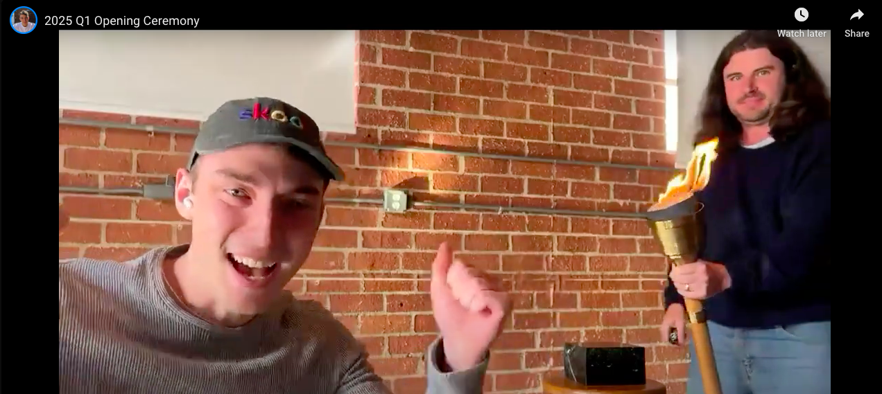 Sam Ovens lighting up the torch at the quarter 1 opening ceremony of the skool games with andrew kirby cheering him on